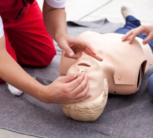 Realistisches Erste-Hilfe-Training mit Reanimationsübungen an Mannequin.