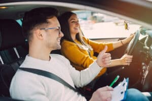 Driving lesson, student with instructor, learning safe driving, behind-the-wheel training, auto school.